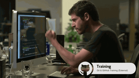 A developer fist-bumping their monitor
